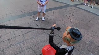 Puppeteer Improvises With a Child at Street Show