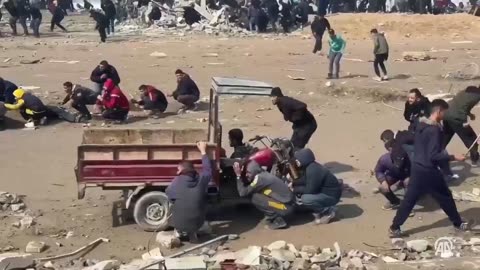 Starving Palestinians rush to aid trucks but IDF terrorists in tanks open fire upon them.