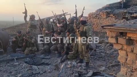 Russian soldiers raise the Russian flag after victorious battle in Bakhmut, Ukraine