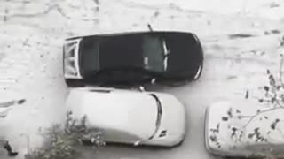 Cars sliding in snow in Tehran