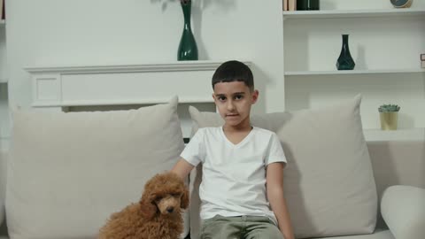 A Boy Petting His Dog While Sitting in a Couch--FH
