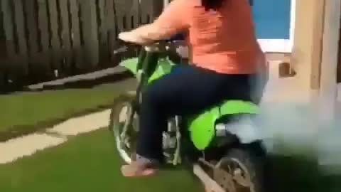 A woman speeds away on a motorcycle and ends up destroying the fence around the house - hilarious