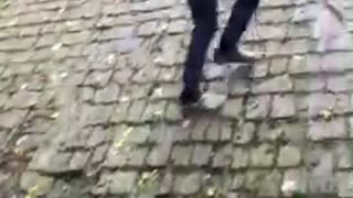 Guy jumps on roof falls on grass