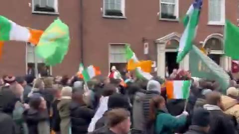 People protesting on the streets of Dublin, Ireland against the influx of immigrants.