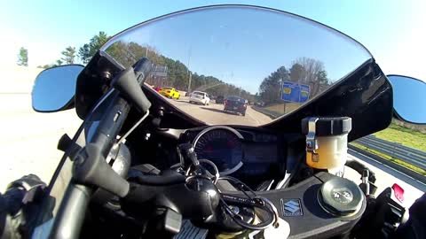 Insane motorcyclist lane splits through heavy traffic