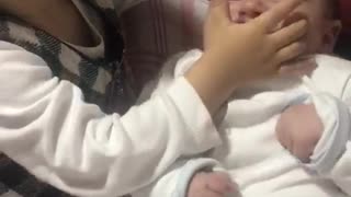 Little girl slaps baby after kissing it