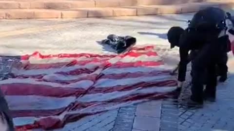 🚨BLM-antifa in Denver set a large American flag on fire.