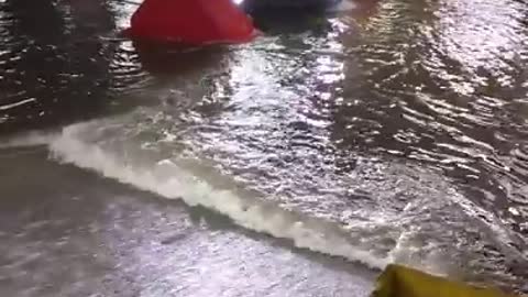Tesla leaving flooded parking lot
