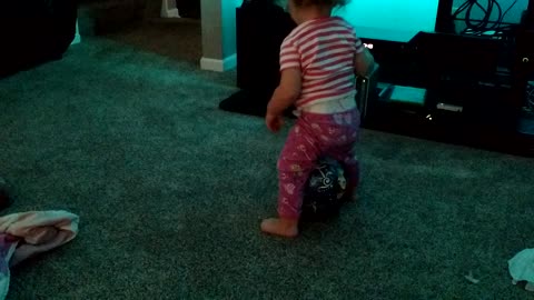 Hysterical toddler tries to sit on ball