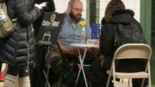 Man and woman playing connect 4 at station