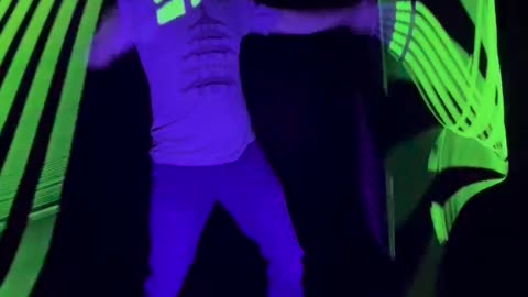 Man Practices With Glow in the Dark Whips At Night