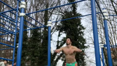 Guy does gymnastics flip on park jungle gym and falls off