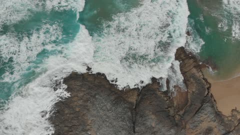 Ocean waves in contact with rocks