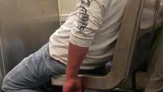 Man white shirt red hat falling asleep on subway train