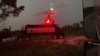 Helicopter Spray operation at dusk.