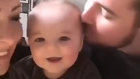 Parents kissing their beautiful cute baby