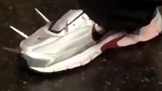Man has nails on silver red shoes