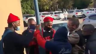 A learner wearing EFF regalia being manhandled