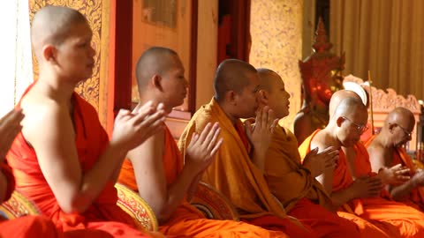 Monks praying inside a Buddhist temple