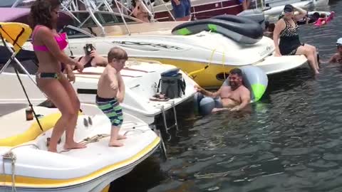 Boy Dances Like A Professional During A Lake Boat Race