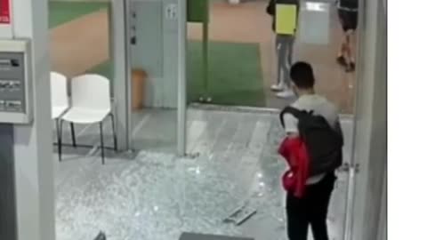 Woman walks right into glass door, sends it shattering