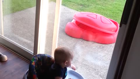 Twin boys extremely entertained by outdoor puppy