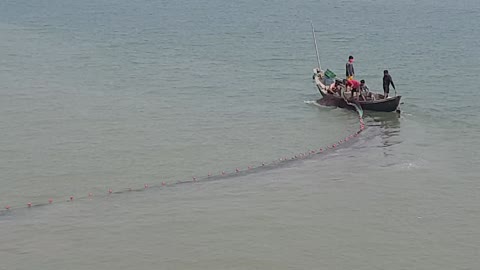 Fishermen cast nets in the sea to catch fish. Maheshkhali Island, Cox's Bazar