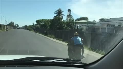 Guy Fitting Almost 7 Bags in Front of Him While Driving a Bike