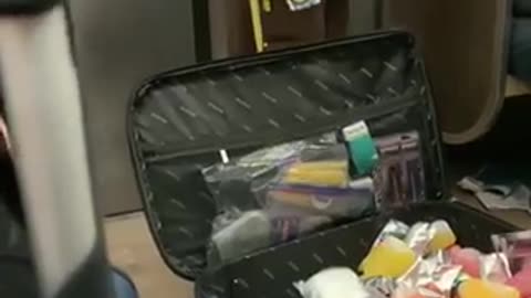 Man sells pepper spray, mixed drinks, and capri sun in a suitcase on subway train