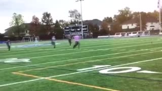 Kids running across football field black shirt girl faceplants