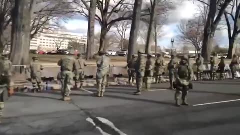 Majority of the military with their backs turned to Biden’s motorade as it passed by