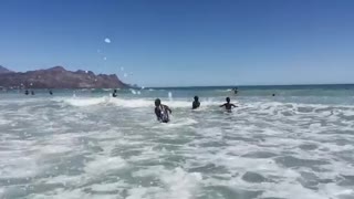 Strand Beach full of Cape Town people enjoying first day on the beach