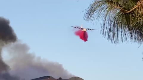 Plane drops fire retardant over Chino Hills State Spark in California