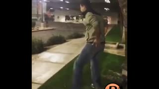 Guy tries to swing on street sign