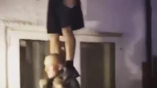 Guy white shirt on top of friends shoulders falls and dances