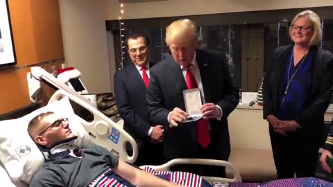 Trump awards wounded soldier Purple Heart during visit to Walter Reed