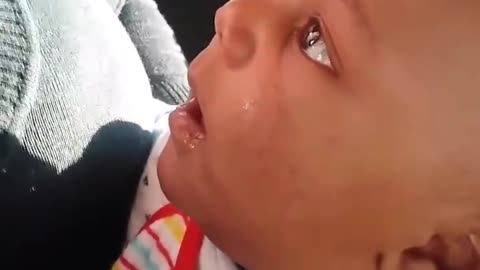 Baby laughs at mother blowing bubble with gum