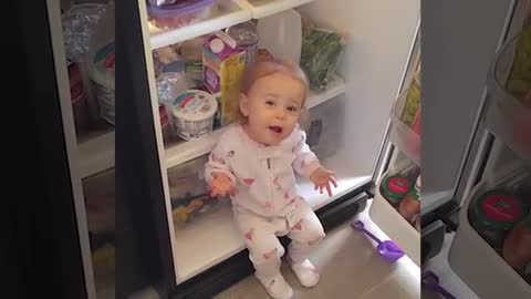 baby opens the fridge