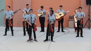 A group of mariachi students playing a Mexican song.