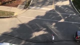 Guy tosses drink from balcony and other guy catches it from below