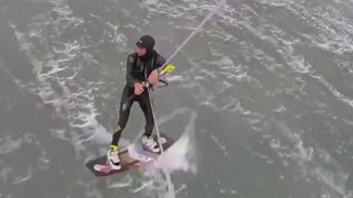 Guy kitesurfing falls down in water