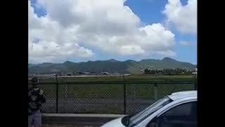 Plane taking off from st marteen airport near a beach