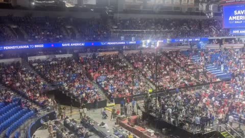Watching people fill seats in the Trump rally.