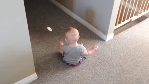 Baby tries to catch light