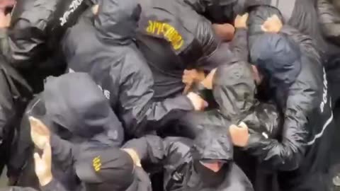 "A crowd of security forces in Georgia brutally beat a detained protester. After