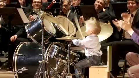 3-year-old boy plays drums