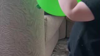 Cute baby and green balloon