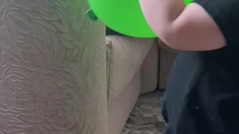 Cute baby and green balloon