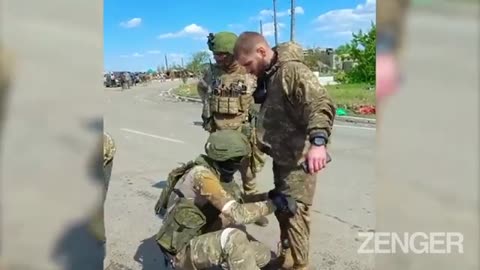 Captured Ukrainian soldiers show their tattoos.