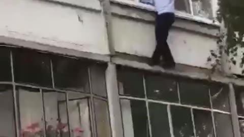 A policeman miraculously saved a child who was trying to be thrown out of a window